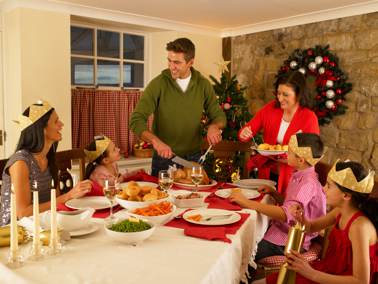 Family serving Christmas dinner