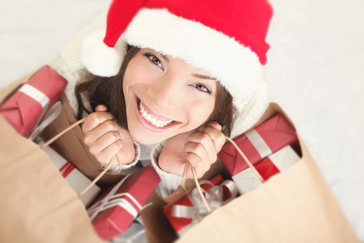 Woman shopping for christmas gifts with shopping bags and santa hat
