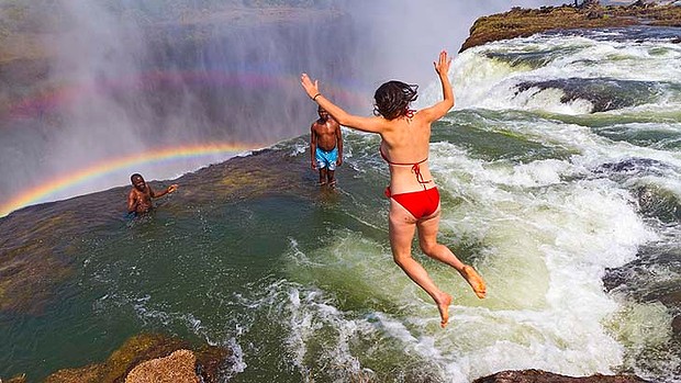 A lady is jumping at Devil's Pool Victoria Falls