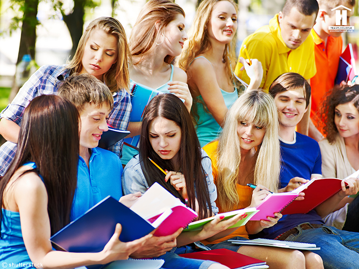 Group students with notebook on bench outdoor