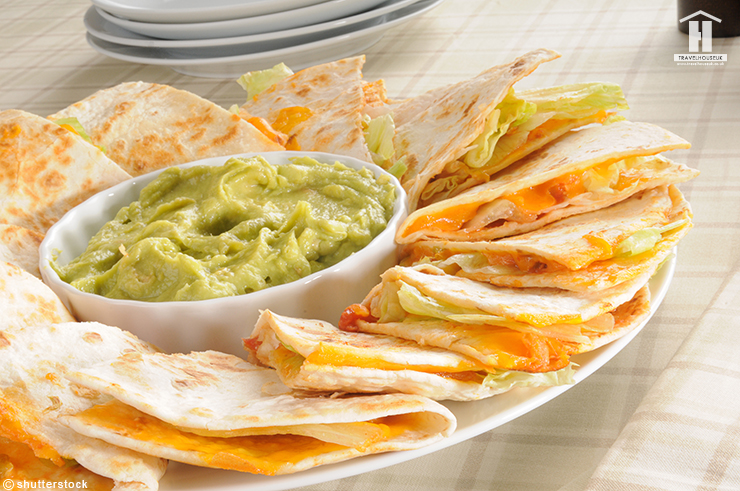 A plate of cheese quesadillas with guacamole